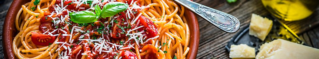 Bowl of Spaghetti with tomato sauce on rustic wooden table